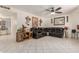 Spacious living room featuring tile floors, ceiling fan, and a comfortable leather sofa at 2207 N 53Rd Ave, Phoenix, AZ 85035