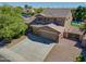 Aerial view of a spacious home showcasing a three car garage, lush landscaping, and a refreshing backyard pool at 2592 E San Rafael Trl, Casa Grande, AZ 85194