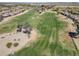 A view of the verdant golf course, enhanced by mature trees in an aerial view at 2592 E San Rafael Trl, Casa Grande, AZ 85194