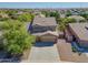 Aerial view of a beautiful home showcasing a three car garage, lush landscaping, and a refreshing backyard pool at 2592 E San Rafael Trl, Casa Grande, AZ 85194