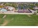 Beautiful aerial view featuring golf course, swimming pool, tennis courts, and clubhouse at 2592 E San Rafael Trl, Casa Grande, AZ 85194