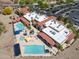 Stunning aerial of the community pool, jacuzzi, palm trees, and plenty of lounge seating at 2592 E San Rafael Trl, Casa Grande, AZ 85194