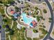 Aerial view of neighborhood amenities featuring swimming pool, sports courts, playground, and park areas at 2592 E San Rafael Trl, Casa Grande, AZ 85194