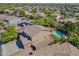 Aerial view of a backyard with a refreshing pool, covered patio, and lush landscaping for outdoor entertainment at 2592 E San Rafael Trl, Casa Grande, AZ 85194
