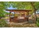 Charming backyard featuring an outdoor kitchen and mature trees at 2592 E San Rafael Trl, Casa Grande, AZ 85194