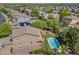 Aerial view of the backyard featuring a sparkling pool, shaded patio, lush landscaping, and outdoor living spaces at 2592 E San Rafael Trl, Casa Grande, AZ 85194