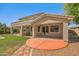 Back exterior featuring a covered patio and a well manicured lawn at 2592 E San Rafael Trl, Casa Grande, AZ 85194