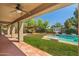 Backyard featuring a covered patio, outdoor kitchen, and refreshing pool at 2592 E San Rafael Trl, Casa Grande, AZ 85194