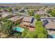 Aerial view of a backyard featuring a refreshing pool, lush landscaping, and a covered patio area perfect for outdoor living at 2592 E San Rafael Trl, Casa Grande, AZ 85194
