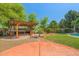 Inviting backyard with a built in grill and bar area, mature landscaping, and pool at 2592 E San Rafael Trl, Casa Grande, AZ 85194