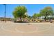 Full court view of community basketball court with the pool area and seating visible in the background at 2592 E San Rafael Trl, Casa Grande, AZ 85194
