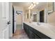Bright bathroom featuring a double vanity, a tile floor and a cabinet for linen at 2592 E San Rafael Trl, Casa Grande, AZ 85194