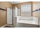 En suite bathroom featuring a soaking tub and separate shower with glass door at 2592 E San Rafael Trl, Casa Grande, AZ 85194