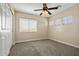 Bright bedroom featuring three windows, carpeted floor and a ceiling fan at 2592 E San Rafael Trl, Casa Grande, AZ 85194
