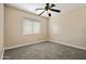 Bedroom with carpet floor, a ceiling fan and a large window with natural light at 2592 E San Rafael Trl, Casa Grande, AZ 85194