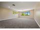 Bright bedroom featuring carpeted flooring, natural light from bright windows and neutral walls at 2592 E San Rafael Trl, Casa Grande, AZ 85194