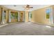 Neutral bedroom with large windows and ceiling fan with neutral carpet at 2592 E San Rafael Trl, Casa Grande, AZ 85194