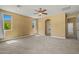 Neutral bedroom with walk-in closet, en-suite bathroom, neutral carpet, large windows, and ceiling fan at 2592 E San Rafael Trl, Casa Grande, AZ 85194