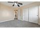 Bright bedroom featuring double closets and a ceiling fan for optimal comfort at 2592 E San Rafael Trl, Casa Grande, AZ 85194