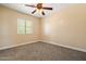 Bedroom with neutral carpet, bright windows, and a ceiling fan at 2592 E San Rafael Trl, Casa Grande, AZ 85194