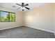 Bedroom featuring a ceiling fan and a large window for plenty of sunlight at 2592 E San Rafael Trl, Casa Grande, AZ 85194