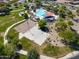 Aerial view of a community park featuring a pool, sports courts, playground, and green space at 2592 E San Rafael Trl, Casa Grande, AZ 85194