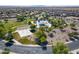 Aerial view of the community park, featuring a playground, pool, and basketball and sand volleyball courts at 2592 E San Rafael Trl, Casa Grande, AZ 85194