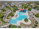 Aerial view of a community pool showcasing a resort-style water park with pools, slides, seating, and recreational areas at 2592 E San Rafael Trl, Casa Grande, AZ 85194