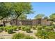 Community entrance with monument sign featuring landscaping, shrubbery and trees at 2592 E San Rafael Trl, Casa Grande, AZ 85194