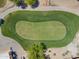 Aerial view of a pristine green golf course featuring well-maintained grass and a scenic landscape at 2592 E San Rafael Trl, Casa Grande, AZ 85194