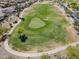 Aerial view of a lush green golf course with manicured lawns and sand traps in a residential community at 2592 E San Rafael Trl, Casa Grande, AZ 85194