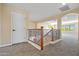 Hallway featuring a beautiful rod iron stair railing and large opening into bonus room at 2592 E San Rafael Trl, Casa Grande, AZ 85194