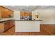 Spacious kitchen with wooden cabinets, stainless steel appliances, granite counters and hardwood floors at 2592 E San Rafael Trl, Casa Grande, AZ 85194