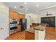 Kitchen with stainless steel appliances, wooden cabinets, granite counters and hardwood floors at 2592 E San Rafael Trl, Casa Grande, AZ 85194