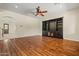 Spacious living room boasting gleaming hardwood floors and custom built-in shelving, creating an inviting, stylish space at 2592 E San Rafael Trl, Casa Grande, AZ 85194