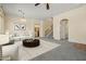 Spacious living room boasts neutral tones, carpet, and seamless flow; ideal for gatherings and relaxation at 2592 E San Rafael Trl, Casa Grande, AZ 85194
