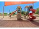 Closer shot of the colorful playground equipment with climbing structures and slides in a shaded, sandy area at 2592 E San Rafael Trl, Casa Grande, AZ 85194