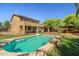Backyard pool featuring a basketball hoop, gazebo, lush green grass, well maintained landscaping and ample patio space at 2592 E San Rafael Trl, Casa Grande, AZ 85194