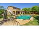 Backyard pool featuring a slide, basketball hoop, gazebo, lush green grass and ample space for outdoor entertaining at 2592 E San Rafael Trl, Casa Grande, AZ 85194