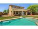 Backyard pool featuring a basketball hoop, lush green grass, well maintained landscaping and ample patio space at 2592 E San Rafael Trl, Casa Grande, AZ 85194