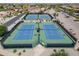Aerial view of the community tennis courts, showcasing well-maintained blue courts surrounded by fencing at 2592 E San Rafael Trl, Casa Grande, AZ 85194