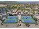 Aerial view of tennis courts showcasing location adjacent to residential area and surrounding golf course at 2592 E San Rafael Trl, Casa Grande, AZ 85194