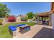 Backyard features a cozy built-in seating area and a fire pit, perfect for entertaining guests outdoors at 3060 E Hope St, Mesa, AZ 85213