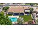 Aerial view of backyard features a sparkling pool, covered patio with seating, and well-manicured landscaping at 3060 E Hope St, Mesa, AZ 85213