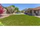 Expansive backyard showcasing a sparkling pool, outdoor kitchen and ample seating for entertaining and relaxation at 3060 E Hope St, Mesa, AZ 85213