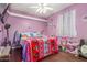 A vibrant bedroom featuring hardwood floors, lively decor, and a cozy bed at 3060 E Hope St, Mesa, AZ 85213