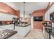 A modern kitchen boasting an island, granite countertops, stainless steel appliances, and unique lighting at 3060 E Hope St, Mesa, AZ 85213