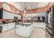 Spacious kitchen featuring white cabinetry, a central island with sink, and tile flooring at 3060 E Hope St, Mesa, AZ 85213