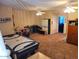 Spacious room with carpet flooring, fans, and potential for various activities at 3060 E Hope St, Mesa, AZ 85213