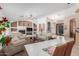 Spacious living room with fireplace, shelving, ceiling fan, and large tile flooring at 3060 E Hope St, Mesa, AZ 85213